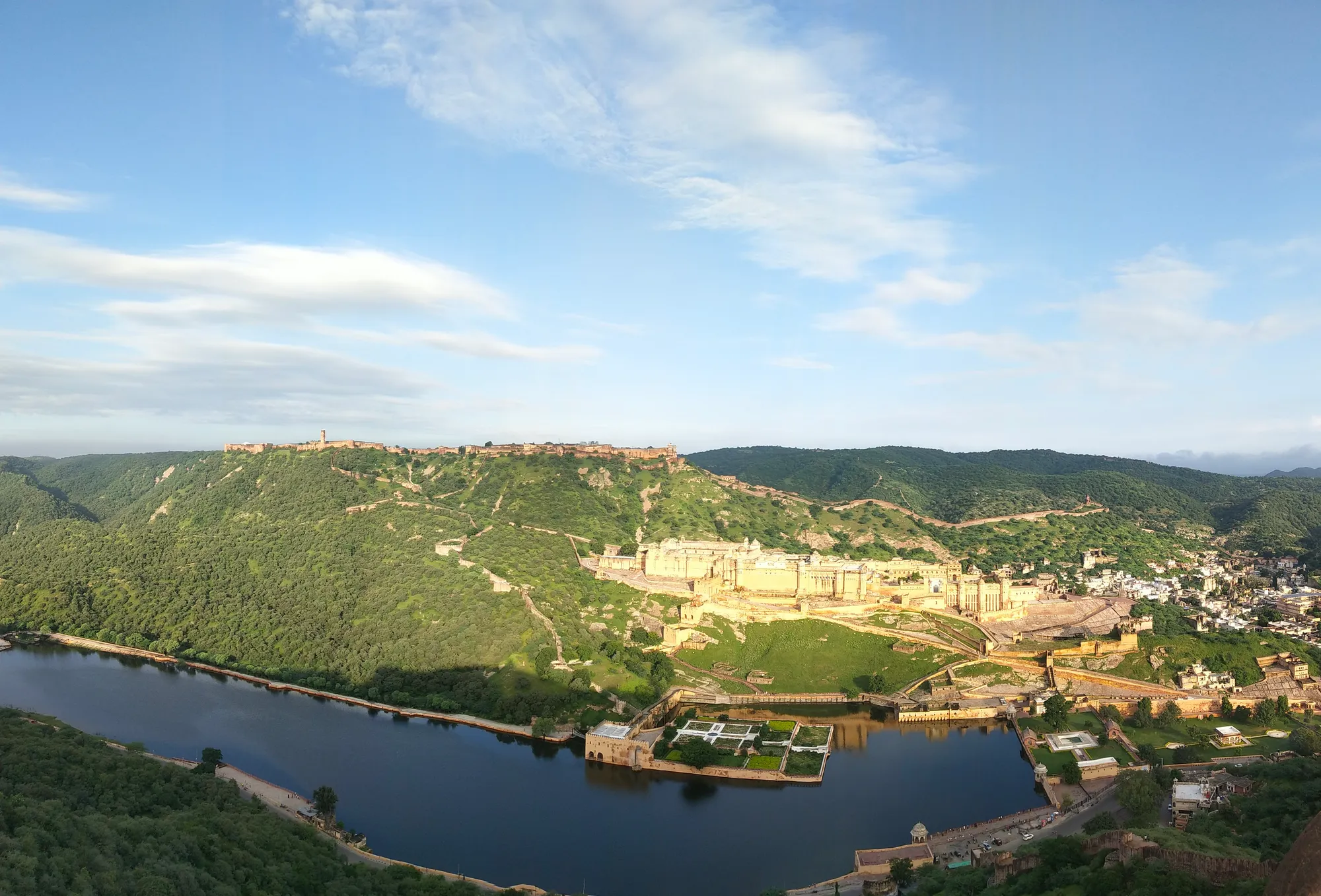 A hilltop fort above a lake with a formal garden set in the water