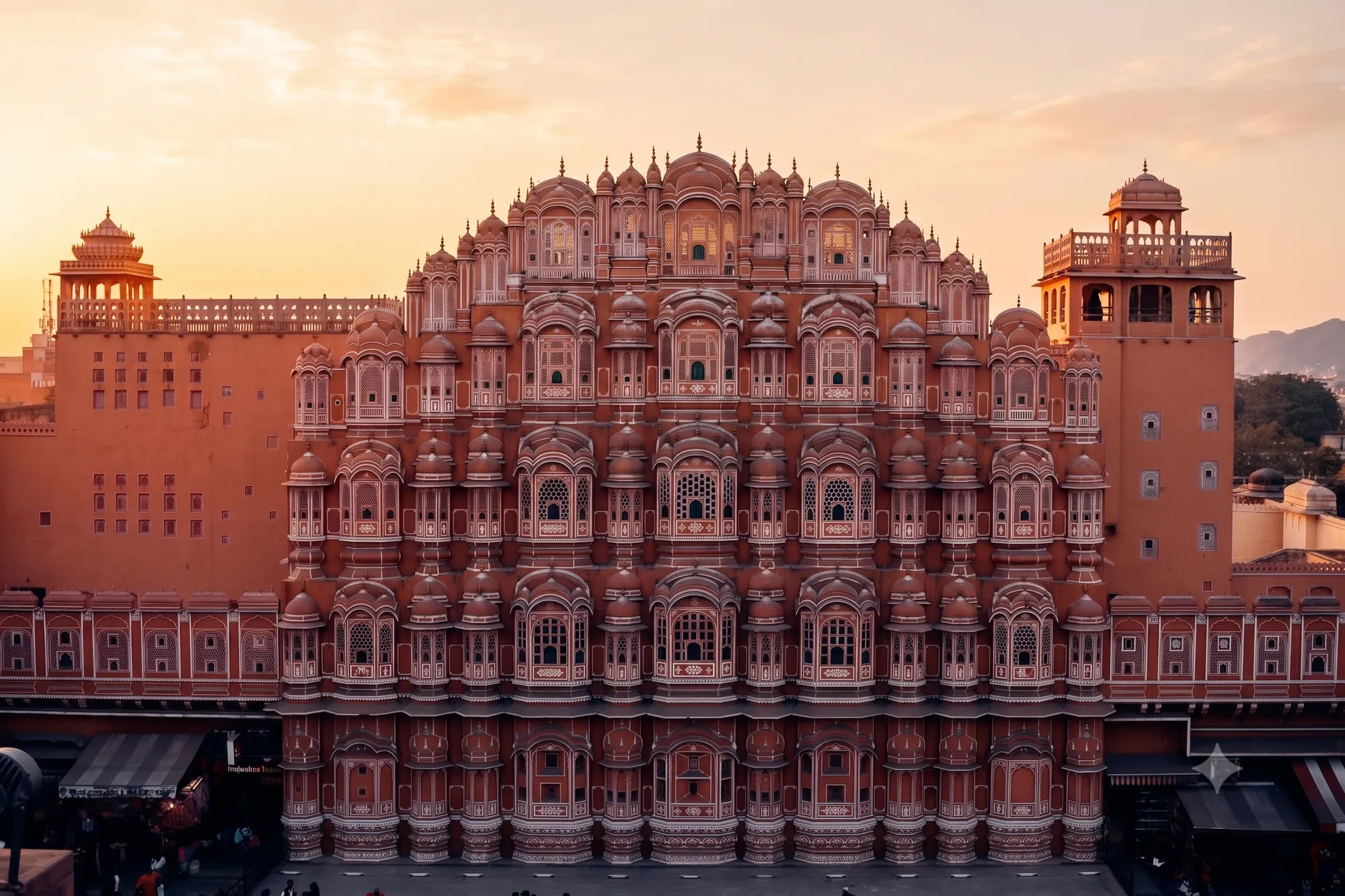 A tiered pink sandstone facade of small windows at sunrise