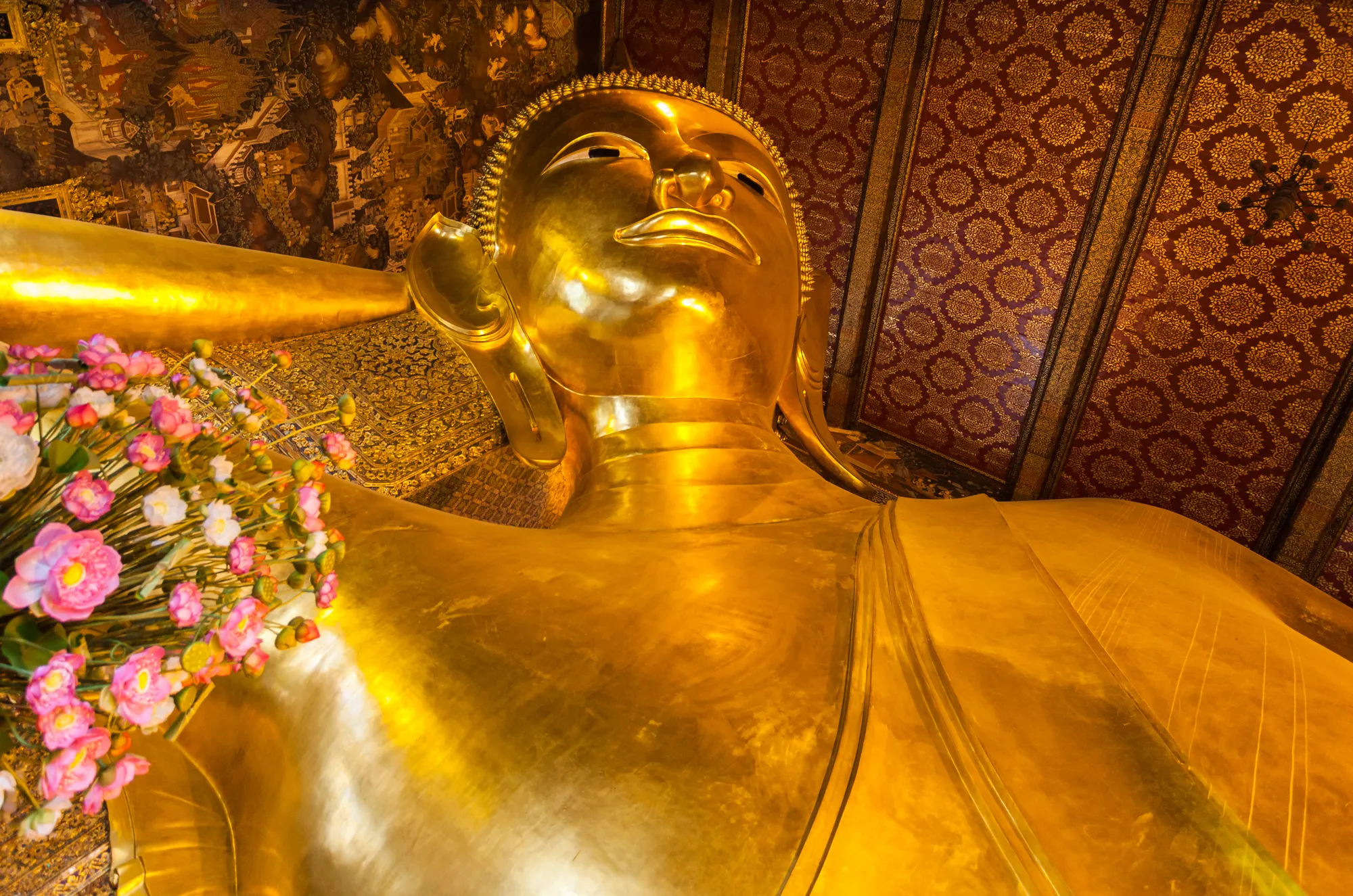 The head and shoulders of the gilded Reclining Buddha at Wat Pho